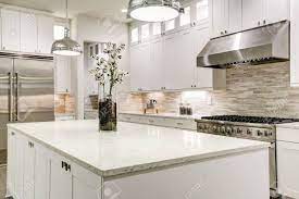 Pure creamy tones to sand found in subway tile room offers a neutral background that allows the kitchen and other kitchen appliances stand out white. Gourmet Kitchen Features White Shaker Cabinets With Marble Countertops Stock Photo Picture And Royalty Free Image Image 72996745