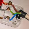 It would be easier to work with the extension cord (guy wire is usually pretty stiff). 1