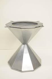 A glass top table with a metal base can make your dining room look chic and elegant. Faceted Hour Glass Dining Center Table Pedestal Base Aluminum Aviator Style At 1stdibs