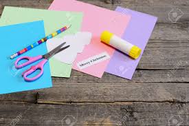 You can make an easy card at home that's completely customized for your loved one. Making A Christmas Greeting Card Step Colored Paper Set Scissors Pencil Tree Template Glue Stick Merry Christmas Wishes Paper Piece On An Old Wooden Table Simple Children Christmas Gift Idea Stock Photo