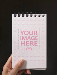 Mockup Generator Template Featuring A Man Holding A Small Notebook In Hand Click On The Placeholder To Upload Your Own Small Notebook Mockup Generator Mockup