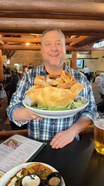 The Pot O’ Gold in an edible tortilla bowl that is filled with chicken  tenders, steak & cheese egg rolls, mozzarella moons, and onion rings  @groundround1969 | Phantom Gourmet | Facebook