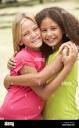 Two Girls In Park Giving Each Other Hug Stock Photo - Alamy