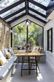 Modern sunroom in white with a variety of indoor plants [from: 5 Stunning Sunroom Design Ideas