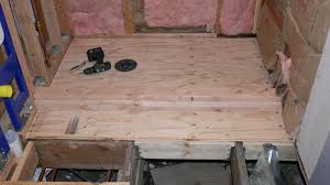 This finished tile floor is installed over a plywood and cement backer board subfloor. How To Build A Shower