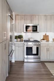 Ikea's kura is usually used as a bunk bed, but it can also be a wonderful canopy bed! Light Brown Oak Kitchen Cabinets With Marble Look Countertops Cottage Kitchen