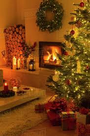 Ambient Fireplace And Candles Illuminating Living Room With Christmas Tree And Decorations Stock Photo Dissolve