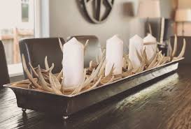 Candles….oh they look lovely in any form or shape and can illuminate your dining tables as centerpieces!candles can either be grouped together and lit up when needed, or you can place single candelabra to add more style to your dining experience. Antler Centerpiece Dining Room Table Centerpieces Table Centerpieces Dining Room Table Decor