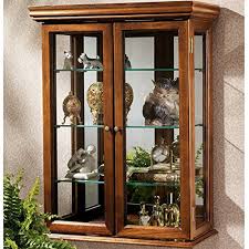 When your child starts moving around the house and grabbing things, your whole universe moves higher and i mean it the cabinet has a minimal and modern design and is divided in two by an inner shelf. Country Tuscan Wall Mounted Curio Cabinet Glass Display Shelves Lighted Case Corner Oak Furniture Doors Wood Storage Coaster Mirrored Door New Buy Online In Bahamas At Bahamas Desertcart Com Productid 58816847