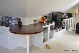 Slanted ceiling leading to low side walls. Custom Storage Solutions Edgewood Cabinetry