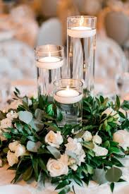 See more ideas about floating candle centerpieces, candle centerpieces, floating candle centerpieces diy. Varying Height Floating Candles On Organic Greens And White Flowers Flower Centerpieces Wedding Candle Wedding Centerpieces Amazing Wedding Centerpieces