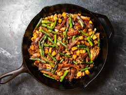 Looking for a tasty pork chop recipe? Crispy Pork Shoulder Hash With Charred Asparagus And Serrano Chili Recipe