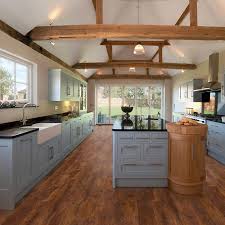 Harmonics Toasted Cinnamon Oak Laminate Moisture Resistant Flooring 20 15 Sq Ft Per Box Oak Laminate Flooring Oak Laminate Kitchen Style