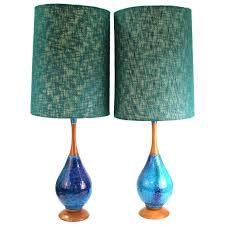 Depending on where you install it, the fan can keep the air feeling clean and cooler, allowing you to get a restful night sleep in the bedroom or relax in the living room. Mid Century Modern Blue Ceramic And Teak Table Lamps With Fabric Shades For Sale At 1stdibs
