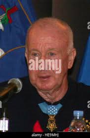 Retired U.S. Air Force Sgt. David Lyles sits with his family, Stacy, from  left, Addison and Ainsley, in Mentor, Ohio,