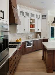 It's a simple design solution that makes the design more fun, dynamic and gives it a bit more contrast and balance. Top 10 Hottest Kitchen Design Trends In 2018 Published In Pouted Online Magazine Kitchen Kitchen Cabinet Design Walnut Kitchen Cabinets Top Kitchen Cabinets