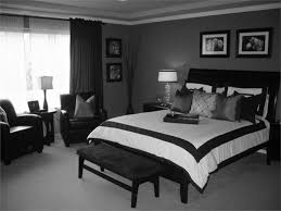 Black and white wallpaper complements a black tufted headboard accenting a bed dressed in black border hotel bedding topped with black and gray pillows. Black And Grey Bedroom Designs Bac Ojj