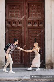 What does casual dating really mean? Young Cheerful And Playful Couple In Casual Clothes Having Fun During Dating Outdoors In Front Of Beautiful Old Door Woman Summer Stock Photo 294792442
