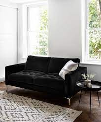 10 Black Sofas For A Dramatic Look Black Sofa Living Room Decor Black And White Living Room Black Living Room