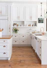They are topped off with black granite countertops for a classy touch. I Love This Kitchen White Cabinets With Copper Rose Gold Hardware Yes White Sub Antique White Kitchen Antique White Kitchen Cabinets Kitchen Cabinet Design