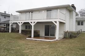 Here is how i built a deck in my backyard.it's a floating deck, which means it simply rests on blocks at ground level, and is not anchored deeply in the ground. Trex Deck With White Railings Posts And Ground Level Trex Deck Lake County Rock Solid Builders Inc