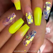 Hands with bright yellow manicure on violet background. Neon Yellow Coffin Acrylic Nails Nail And Manicure Trends