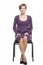 Woman sits a chair. enticing gesture. expresses excitement. crossed ankles,  elbows pressed. Isolated white background. body language Stock Photo by  ©kopitin 91427264
