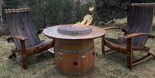 Crafted from durable concrete based composite material, stainless steel burner, hidden propane tank, natural gas orifice, decorative flame glass, lid, and protective cover. Busted Barrel Brand Wine Barrel Fire Pit Colorado Hearth And Home