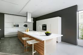 Kitchen island with waterfall edge with open book storage. Contemporary Home With Pool Has Black And White Interior
