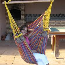 Blue, white, aqua, orange and yellow are woven into a cotton hammock that promises relaxation in comfort. A Brazilian Hammock Chair You Just Sit And Dream Really Well In