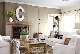 Example of a small french country open concept medium tone wood floor, brown floor and vaulted ceiling living room design in san francisco with white walls, a standard fireplace and a stone fireplace How To Decorate A Small Living Room In Country Style Decoholic
