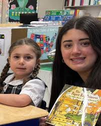 To wrap up March is Reading Month, seniors Elle, Cameron, and Elaina  visited their alma mater, Holy Family. They were so excited to return and  reconnect with some of their former elementary