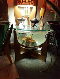 I love the idea of making maximum use of the space you have available by combining the best of both worlds. Mid Century Terrarium Fish Bowl Wooden Cradle Perspex Bowl Glass Lid Smallest In Set Of 3 Atomic Table Li Fish Tank Coffee Table Wooden Cradle Terrarium Table