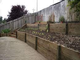 Retaining Wall With 2x12 Pressure Treated Wood 2 Landscaping Retaining Walls Sloped Backyard Landscaping Garden Retaining Wall