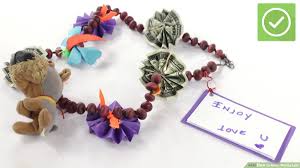 Then, secure the ends of the candy bar with a piece of tape or ribbon. How To Make Money Leis 13 Steps With Pictures Wikihow