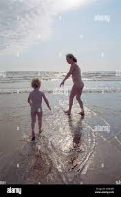 mother and son going for a nude swim in the sea by Aberdyfy Aberdovey North  West Wales Stock Photo - Alamy