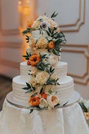 White wedding cake cascading flowers. 4 Tiered Round White Wedding Cake With Cascading Orange And Ivory Flowers With Greenery Marry Me Tampa Bay Most Trusted Wedding Vendor Search And Real Wedding Inspiration Site