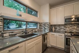 This look is even applied when your kitchen area at the first time has a traditional style. Black And White Thin Tile Backsplash In Modern Kitchen Featuring Stainless Steel Appliances And Gray Countertops Hgtv