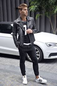 Black And White Chucks Mens Black Jeans A Sporty Print Tee A Black Moto Jacket And White Chucks Mens Street Style Mens Outfits Latest Mens Fashion Trends