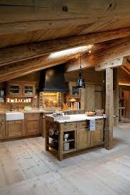 A Chalet Kitchen With Wooden Beams And A Skylight A Wooden Kitchen Island And Cabines A Black Hood And La Rustic Cabin Kitchens Cabin Kitchens Rustic Kitchen