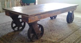 Sporting a weathered white wash, this table's base includes one open shelf for displaying coffee table books or fanning out issues of your favorite magazines, while hidden wheels make it easy to move the table for parties and events. Industrial Coffee Table With Wheels