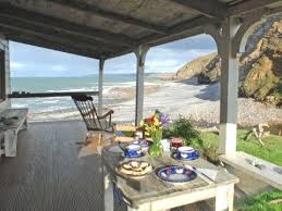 1920s Seaside Cottage Rental In Cornwall The Covered Porch Looks Over The Sea Cliffs Featured In The Mo Seaside Cottage Beach Cottages Beach Cottage Style