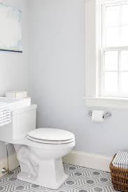 A beige and blue vintage bath rug covers gray bathroom floor tiles. Gray Bathroom Paint Colors Design Ideas