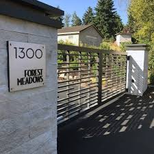 The aging asphalt driveway was replaced by precast concrete pavers that coordinate with a new walkway of sandwashed concrete pads. Top 60 Best Driveway Gate Ideas Wooden And Metal Entrances