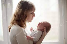 Young Mother With Crying Baby Stock Photo By ©Ababaka 58879983