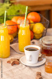 You can drop it right into the cup or squeeze it over the surface to brighten the coffee's flavor and counteract any bitterness. Breakfast With Coffee Cups Orange Juice Makaron The Outdoor Terrace Stock Photo Adobe Stock