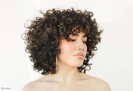Section off a middle section of hair from the top of each ear, and tie into a. 29 Most Flattering Short Curly Hairstyles To Perfectly Shape Your Curls