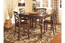 Two brown faux leather upholstered stools easily tuck beneath the table when not in use. Ashley Furniture Homestore Counter Height Dining Room Tables Dining Table Pub Dining Set