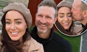 AFL star Nathan Buckley kisses his girlfriend Brodie Ryan as they celebrate  one year together