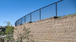 Measure the area and get the right fencing. Fence Post In Retaining Wall Cornerstone Wall Solutions
